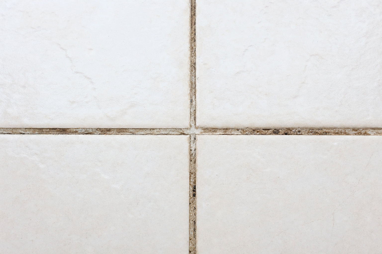 Grimy grout lines before steam cleaning
